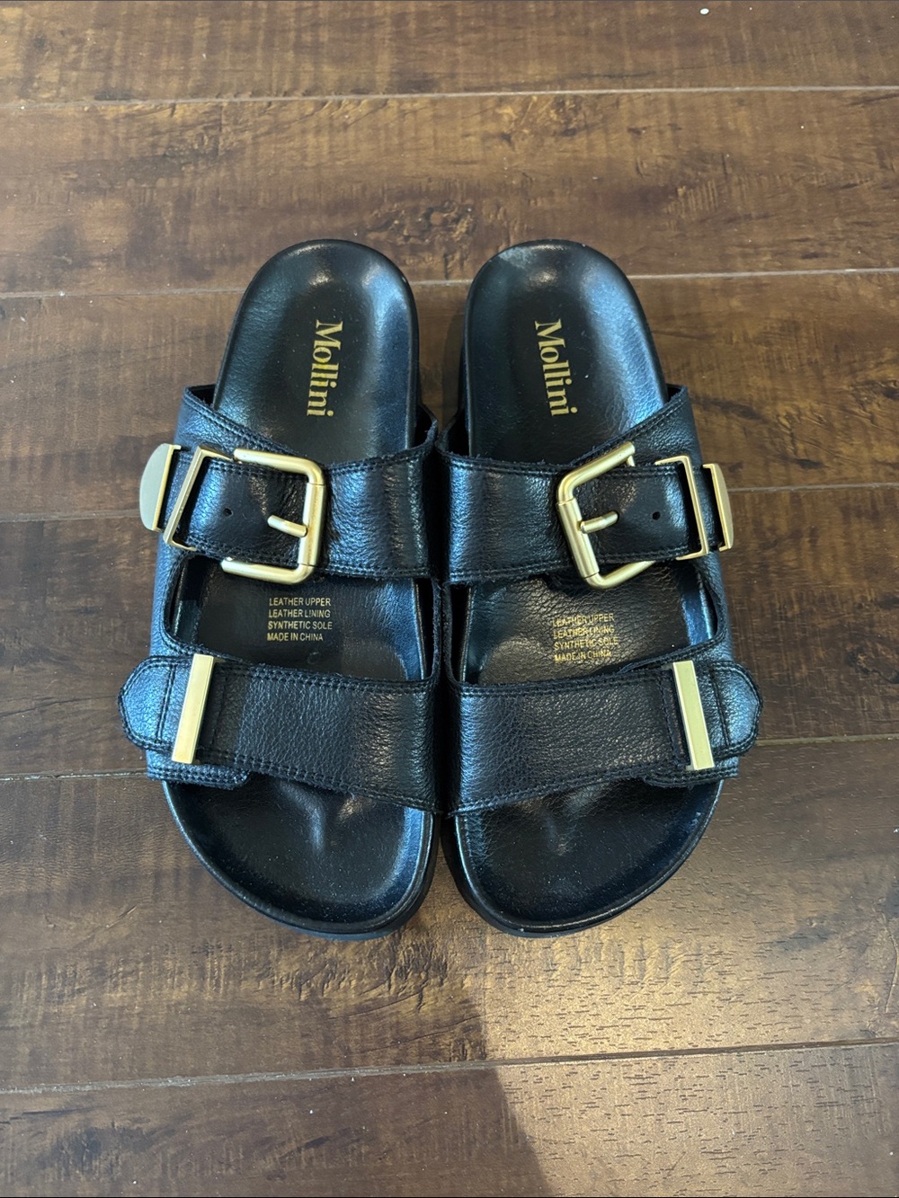 Mollini Black Womens Slide Sandals with Gold Buckle Accents